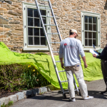 Lauro Painting crew consulting with a homeowner before starting an exterior painting project.